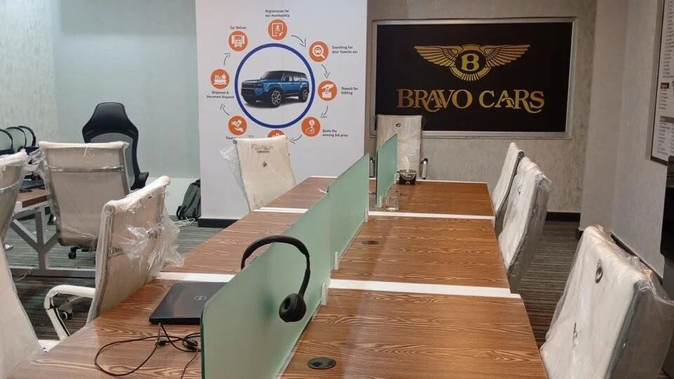 Office interior with wooden workstations and glass desk dividers by Punjab Interiors Group, Lahore